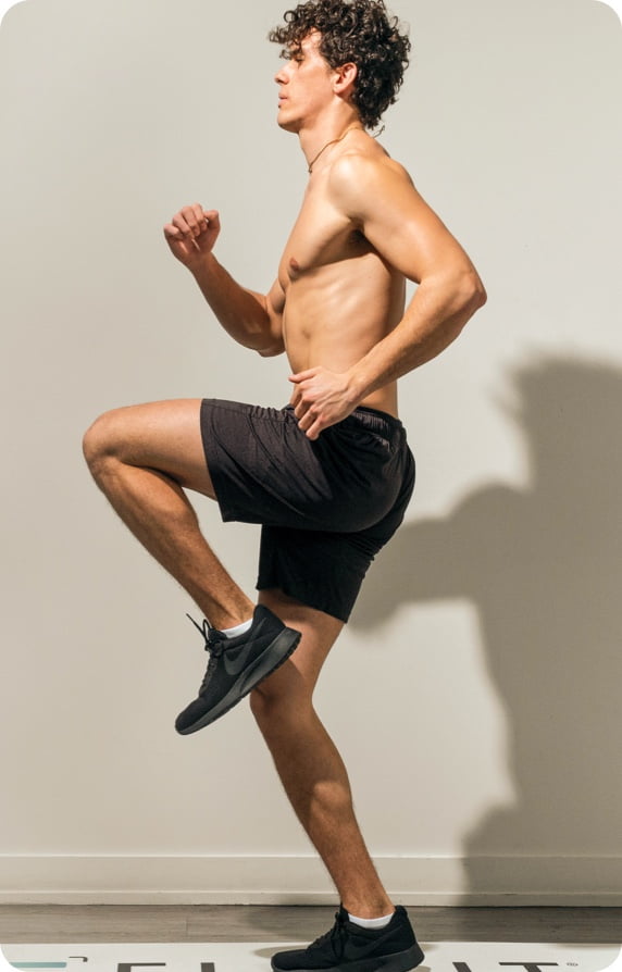 Fit man running in place indoors